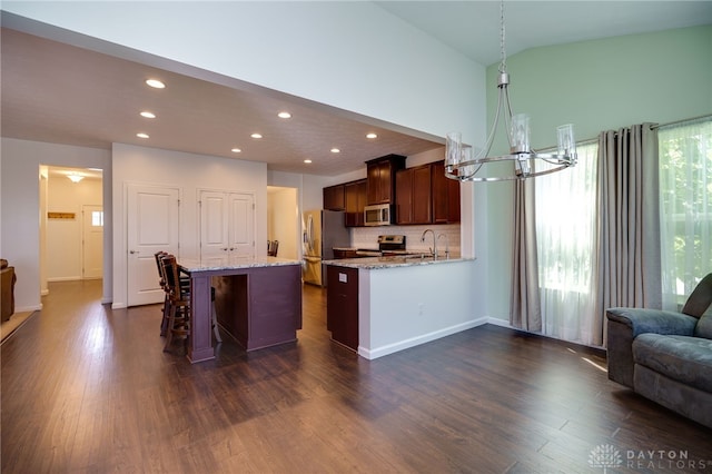 2933 E Ambrosia Ln, Xenia, OH 45385 - kitchen with appliances with stainless steel finishes, a chandelier, recessed lighting, dark wood-type flooring, and a towering ceiling