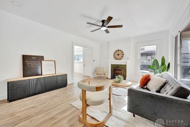 1200 Wyoming St, Dayton, OH 45410 - living room featuring a fireplace, light wood-type flooring, and a ceiling fan