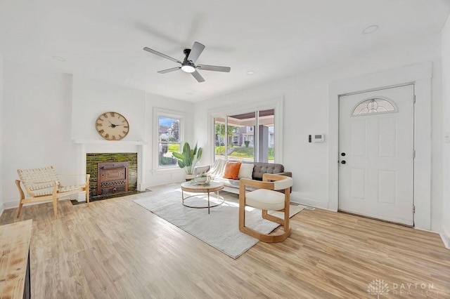 1200 Wyoming St, Dayton, OH 45410 - living room with ceiling fan, a fireplace with flush hearth, and light wood-type flooring