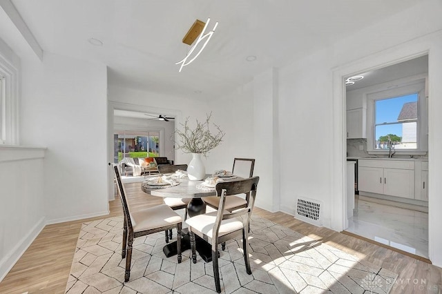1200 Wyoming St, Dayton, OH 45410 - dining space with light wood-style flooring, plenty of natural light, and ceiling fan