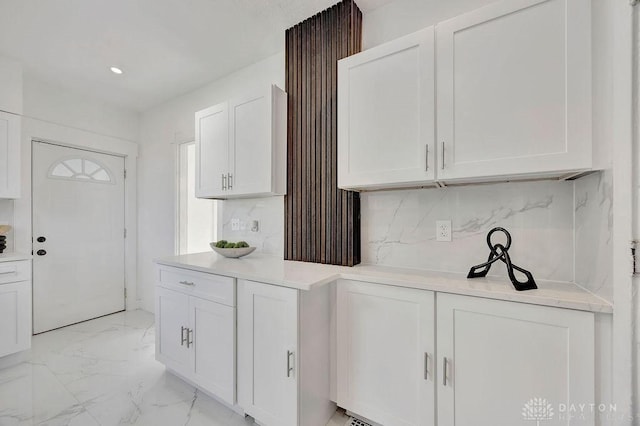 1200 Wyoming St, Dayton, OH 45410 - kitchen with backsplash, white cabinetry, light countertops, light marble finish floors, and recessed lighting
