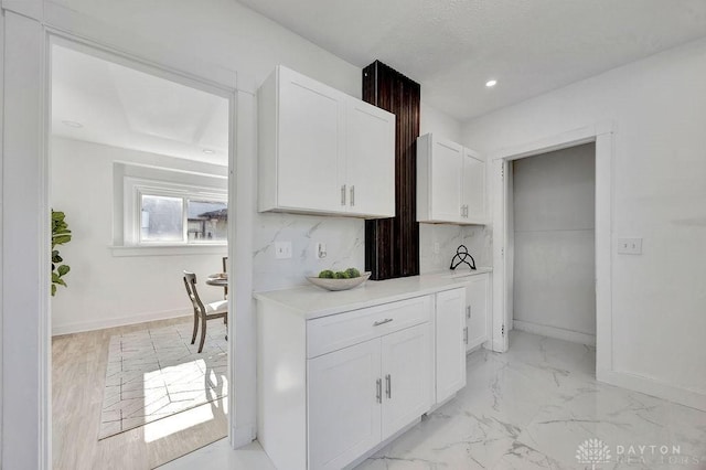 1200 Wyoming St, Dayton, OH 45410 - kitchen with white cabinets, light countertops, recessed lighting, and light marble finish flooring