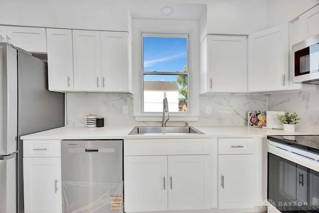 1200 Wyoming St, Dayton, OH 45410 - kitchen featuring stainless steel appliances, white cabinetry, tasteful backsplash, and light countertops