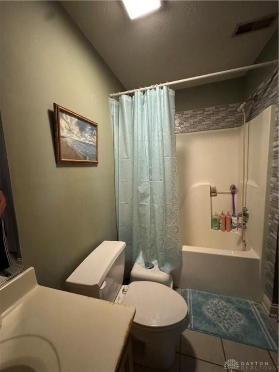428 E Center St, Germantown, OH 45327 - full bath with vanity, shower / bathtub combination with curtain, tile patterned flooring, and lofted ceiling