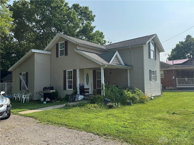 428 E Center St, Germantown, OH 45327 - traditional home with a porch, a front yard, and a shingled roof