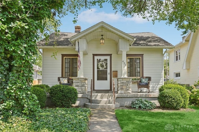 439 Monteray Ave, Oakwood, OH 45419 - bungalow-style home with covered porch, a chimney, and roof with shingles