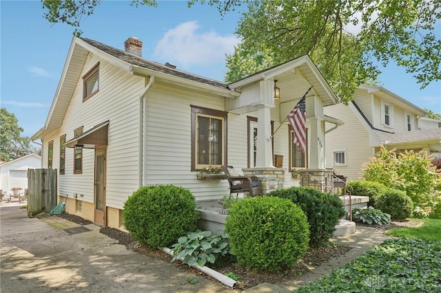 439 Monteray Ave, Oakwood, OH 45419 - view of front facade featuring a chimney, a detached garage, and an outdoor structure