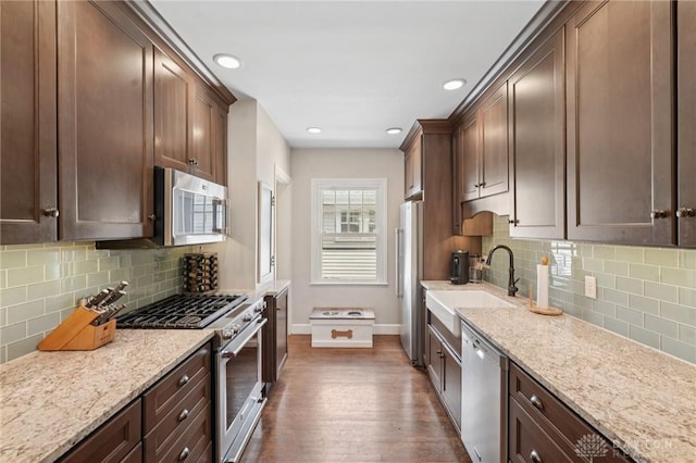 439 Monteray Ave, Oakwood, OH 45419 - kitchen with stainless steel appliances, dark wood-style flooring, light stone counters, decorative backsplash, and recessed lighting