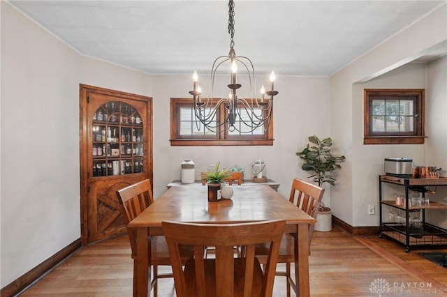 439 Monteray Ave, Oakwood, OH 45419 - dining room with light wood finished floors, a chandelier, and ornamental molding