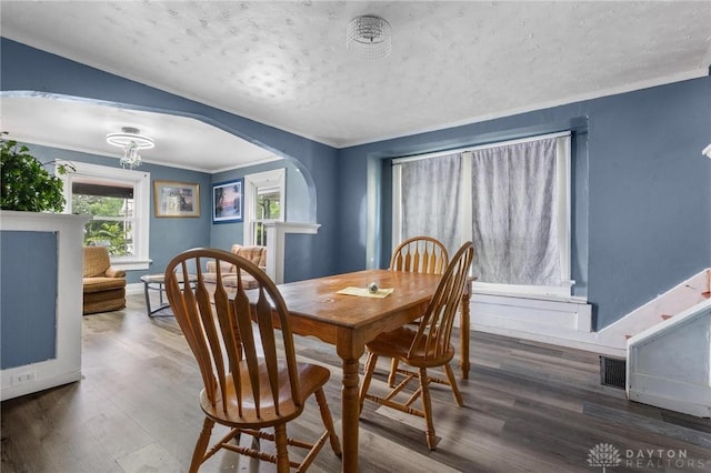 19 S Alder St Unit 21, Dayton, OH 45417 - dining space with arched walkways, wood finished floors, a textured ceiling, and ornamental molding