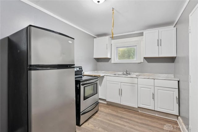 19 S Alder St Unit 21, Dayton, OH 45417 - kitchen with appliances with stainless steel finishes, light countertops, white cabinets, light wood finished floors, and crown molding