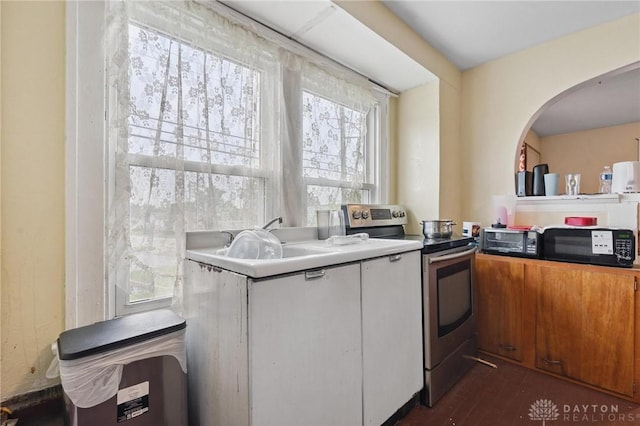 19 S Alder St Unit 21, Dayton, OH 45417 - kitchen with electric range, arched walkways, black microwave, dark wood-style flooring, and brown cabinets