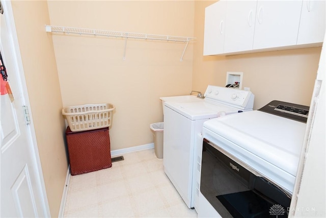 24 Dinsley Pl, Springboro, OH 45066 - washroom featuring cabinet space, washer and dryer, and light flooring