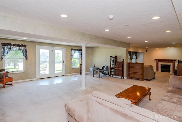 24 Dinsley Pl, Springboro, OH 45066 - carpeted living room with recessed lighting, ornate columns, healthy amount of natural light, and a fireplace