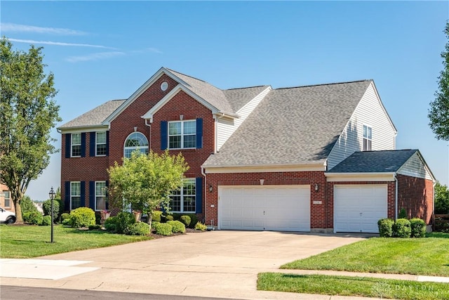 24 Dinsley Pl, Springboro, OH 45066 - colonial-style house featuring an attached garage, a front lawn, concrete driveway, brick siding, and roof with shingles
