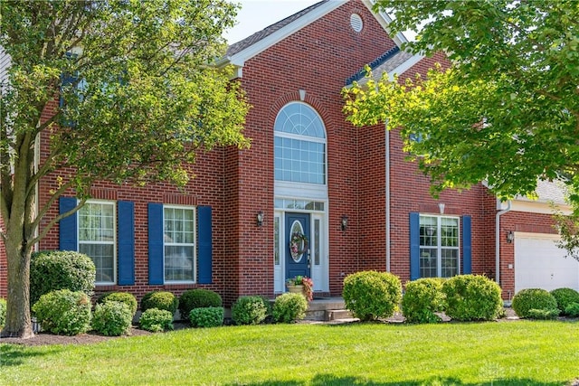 24 Dinsley Pl, Springboro, OH 45066 - traditional-style home with a front yard, brick siding, and an attached garage