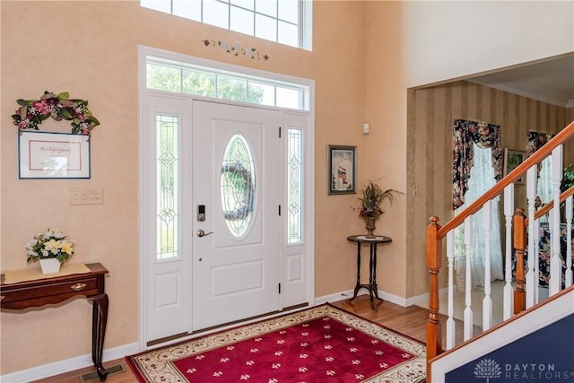 24 Dinsley Pl, Springboro, OH 45066 - foyer entrance with wood finished floors, stairs, and a high ceiling