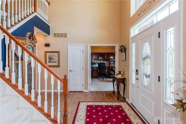 24 Dinsley Pl, Springboro, OH 45066 - foyer entrance with a towering ceiling, wood finished floors, stairway, and healthy amount of natural light