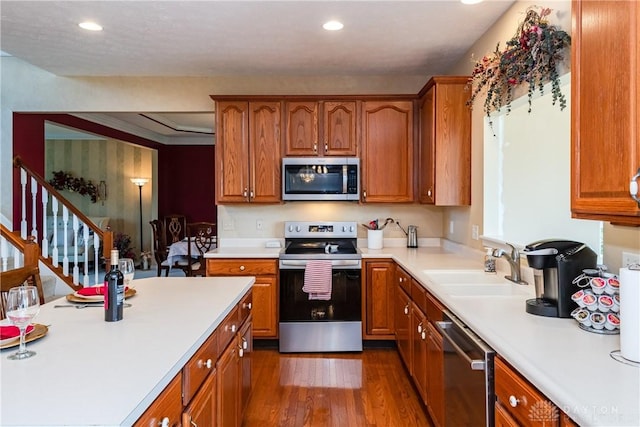 24 Dinsley Pl, Springboro, OH 45066 - kitchen featuring appliances with stainless steel finishes, dark wood-style flooring, light countertops, brown cabinetry, and recessed lighting