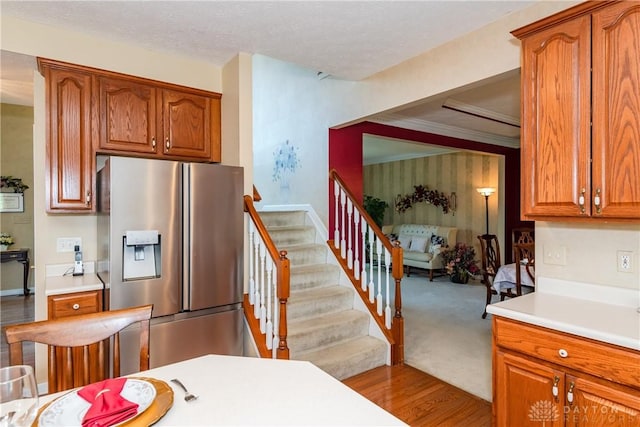 24 Dinsley Pl, Springboro, OH 45066 - kitchen featuring stainless steel fridge, light countertops, brown cabinets, and wood finished floors