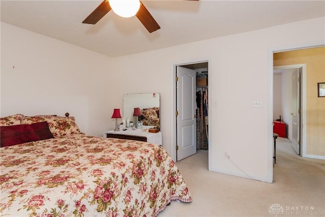 24 Dinsley Pl, Springboro, OH 45066 - bedroom with light carpet, a walk in closet, ceiling fan, and a closet