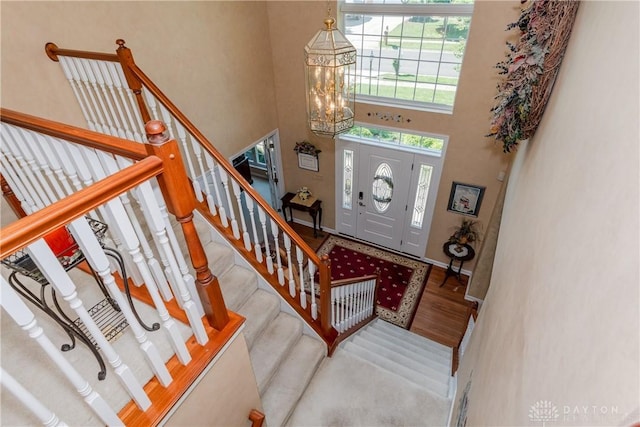 24 Dinsley Pl, Springboro, OH 45066 - entrance foyer featuring a chandelier, stairway, a high ceiling, and wood finished floors