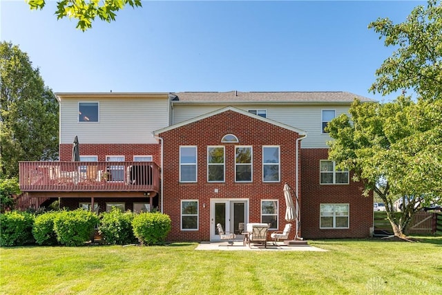 24 Dinsley Pl, Springboro, OH 45066 - rear view of property featuring a lawn, brick siding, a patio, and a wooden deck