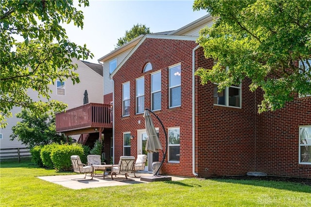 24 Dinsley Pl, Springboro, OH 45066 - rear view of property featuring brick siding, a patio, and a wooden deck