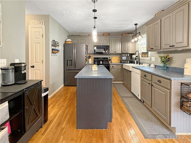 1207 Durbin Ter, Maineville, OH 45039 - kitchen featuring black appliances, a kitchen island, light wood-style floors, and gray cabinetry