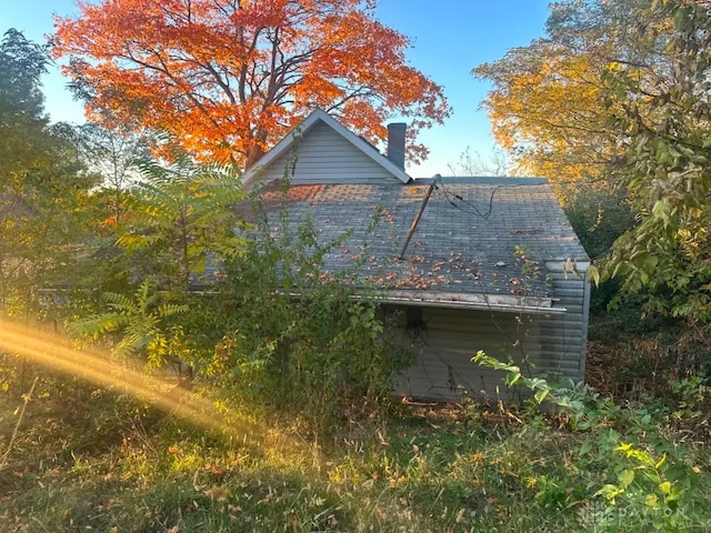 293 S Miami Ave, Xenia, OH 45385 - view of home's exterior with a shingled roof and a chimney