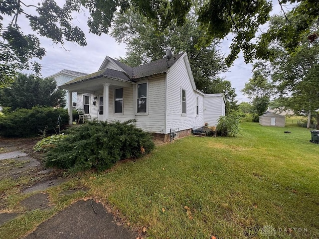 861 E Market St, Xenia, OH 45385 - view of front facade featuring a front lawn, a porch, a storage unit, and a chimney