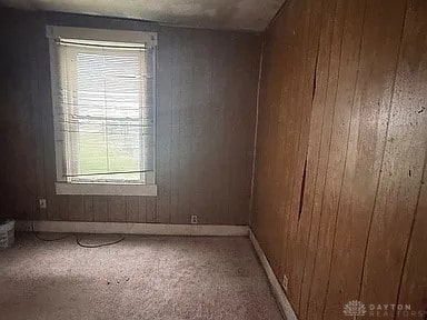 861 E Market St, Xenia, OH 45385 - carpeted empty room with wood walls