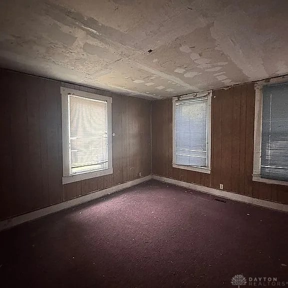 861 E Market St, Xenia, OH 45385 - spare room featuring wood walls