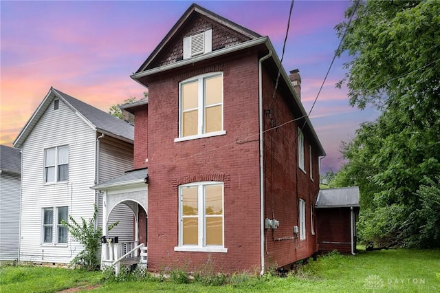36 Leaman St, Xenia, OH 45385 - view of front facade featuring brick siding, a front lawn, and a chimney