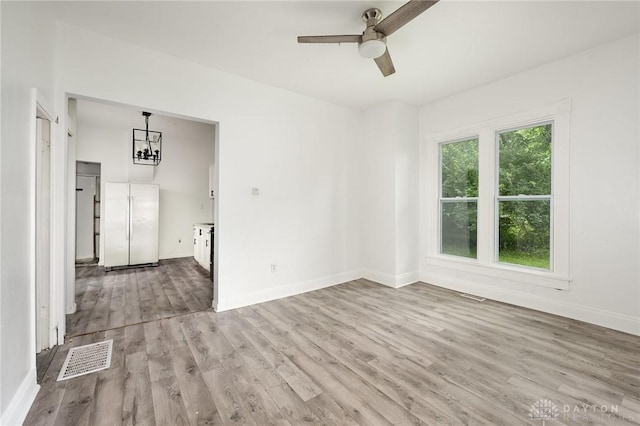 36 Leaman St, Xenia, OH 45385 - unfurnished room featuring wood finished floors, ceiling fan, and a chandelier