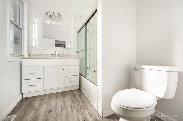 36 Leaman St, Xenia, OH 45385 - full bathroom with vanity, wood finished floors, and enclosed tub / shower combo