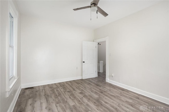 36 Leaman St, Xenia, OH 45385 - spare room featuring wood finished floors, a ceiling fan, and healthy amount of natural light
