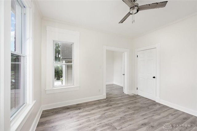 36 Leaman St, Xenia, OH 45385 - empty room featuring ornamental molding, healthy amount of natural light, ceiling fan, and wood finished floors