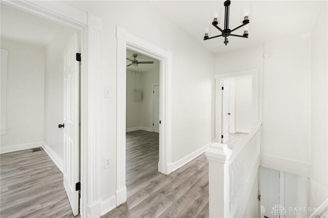 36 Leaman St, Xenia, OH 45385 - hallway featuring light wood finished floors and a chandelier