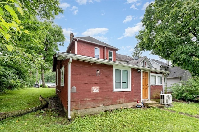 36 Leaman St, Xenia, OH 45385 - view of side of home with a chimney, a yard, and brick siding