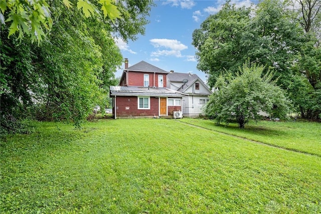 36 Leaman St, Xenia, OH 45385 - rear view of property with a yard and a chimney