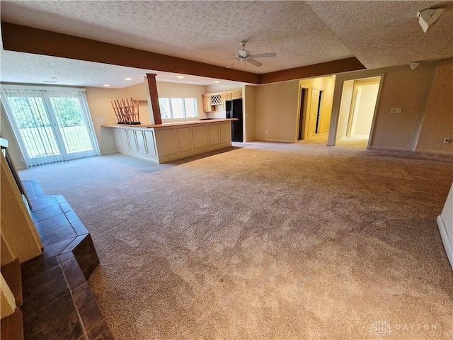 1962 Fountain View Dr, Dayton, OH 45414 - unfurnished living room with carpet floors, a textured ceiling, a ceiling fan, healthy amount of natural light, and recessed lighting
