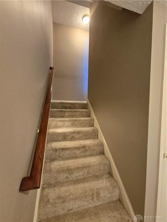 1962 Fountain View Dr, Dayton, OH 45414 - stairway with a textured ceiling and carpet