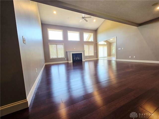 1962 Fountain View Dr, Dayton, OH 45414 - unfurnished living room with vaulted ceiling, hardwood / wood-style flooring, a ceiling fan, a fireplace, and a textured ceiling