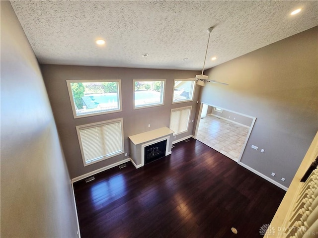 1962 Fountain View Dr, Dayton, OH 45414 - unfurnished living room with a textured ceiling, dark wood-style flooring, recessed lighting, and ceiling fan