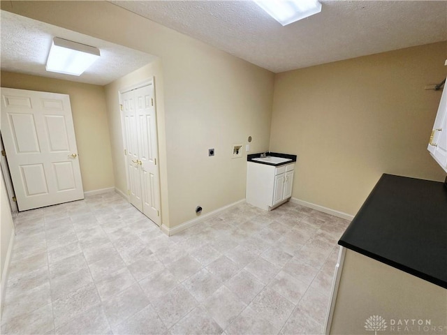 1962 Fountain View Dr, Dayton, OH 45414 - laundry area featuring hookup for an electric dryer, hookup for a washing machine, cabinet space, and a textured ceiling