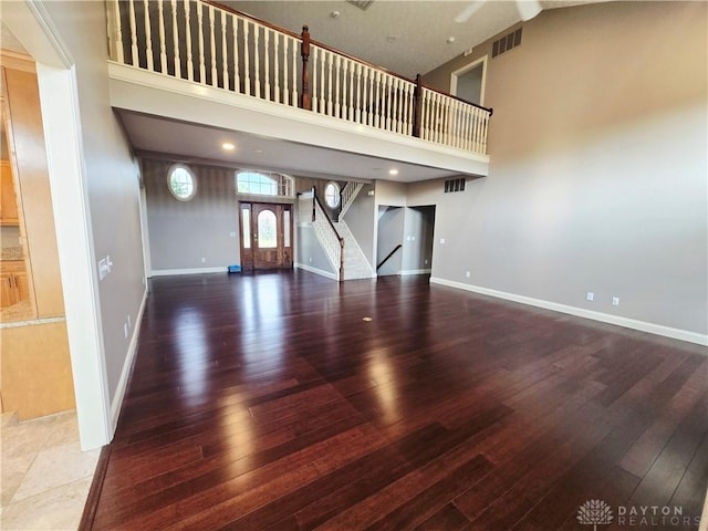 1962 Fountain View Dr, Dayton, OH 45414 - unfurnished living room featuring stairway, a towering ceiling, and wood finished floors