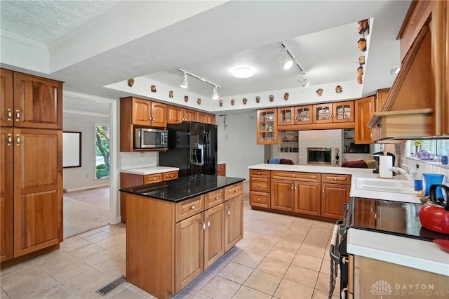 328 Shadywood Dr, Clayton, OH 45415 - kitchen featuring stainless steel microwave, black fridge, range with electric cooktop, light tile patterned floors, and backsplash