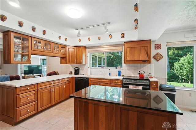 328 Shadywood Dr, Clayton, OH 45415 - kitchen with black appliances, brown cabinetry, a peninsula, and light tile patterned flooring
