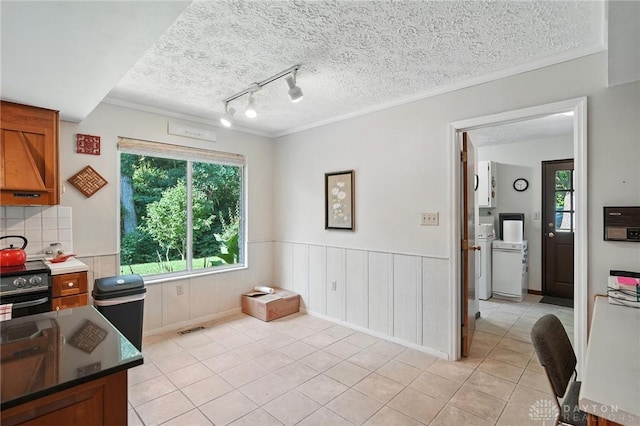 328 Shadywood Dr, Clayton, OH 45415 - kitchen with electric stove, a textured ceiling, light tile patterned flooring, track lighting, and crown molding
